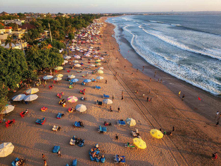 Seminyak beach club aerial with sunbeds at sunset