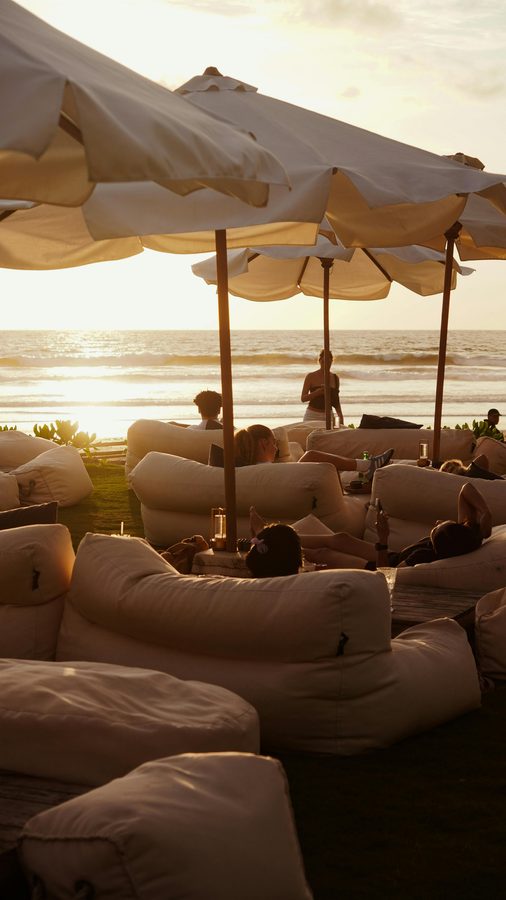 Luxury beach club beanbags at golden hour in Seminyak, Bali